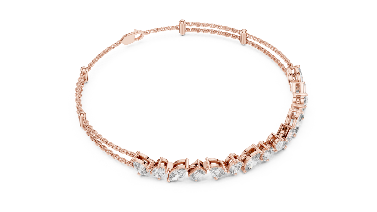 Marquise and emerald diamond tennis bracelet featuring mixed-cut sparkling stones in an elegant chain design by Aortas Jewels.
