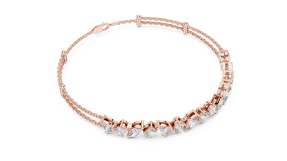 Marquise and emerald diamond tennis bracelet featuring mixed-cut sparkling stones in an elegant chain design by Aortas Jewels.