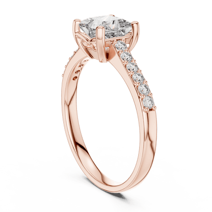 Classic pavé solitaire diamond engagement ring featuring a round-cut center stone in a four-prong setting with a sparkling pavé diamond band by Aortas Jewels.