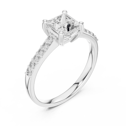 Classic pavé solitaire diamond engagement ring featuring a round-cut center stone in a four-prong setting with a sparkling pavé diamond band by Aortas Jewels.
