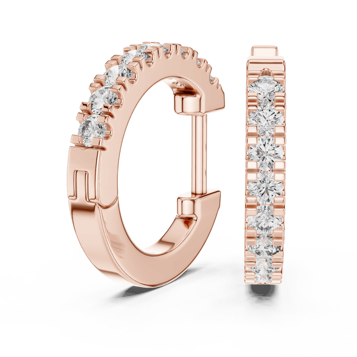 Diamond huggie hoop earrings featuring a row of sparkling round stones with a secure hinged closure by Aortas Jewels.