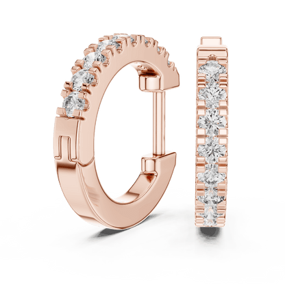 Diamond huggie hoop earrings featuring a row of sparkling round stones with a secure hinged closure by Aortas Jewels.