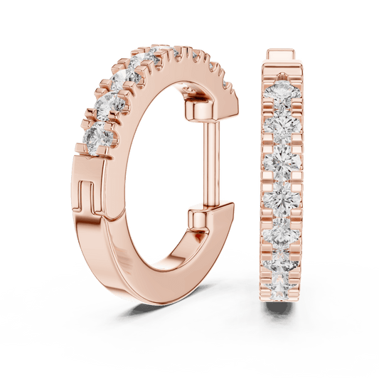 Diamond huggie hoop earrings featuring a row of sparkling round stones with a secure hinged closure by Aortas Jewels.