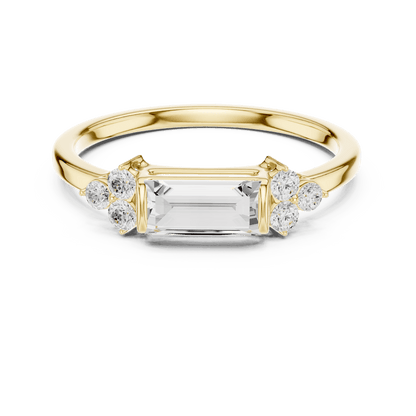 Emerald Cut Diamond Three-Stone Engagement Ring featuring an emerald-cut center stone with round diamond side accents on a polished band by Aortas Jewels.