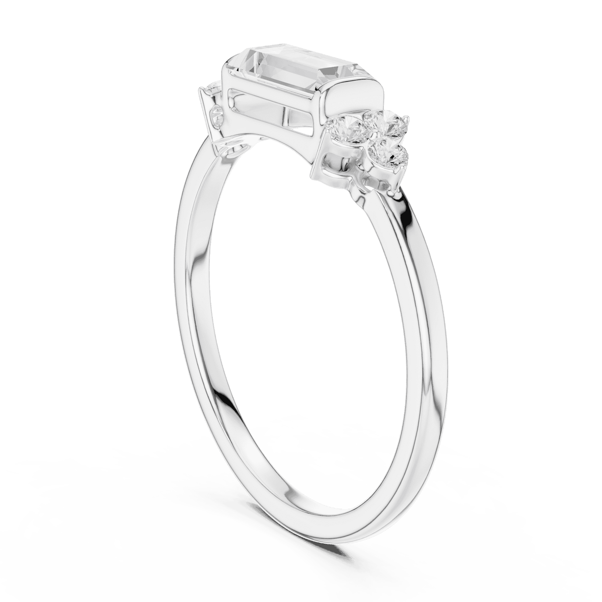 Emerald Cut Diamond Three-Stone Engagement Ring featuring an emerald-cut center stone with round diamond side accents on a polished band by Aortas Jewels.