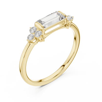 Emerald Cut Diamond Three-Stone Engagement Ring featuring an emerald-cut center stone with round diamond side accents on a polished band by Aortas Jewels.
