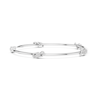 Minimalist floral crystal bangle bracelet featuring delicate flower-inspired charms on a sleek polished silver-tone bangle by Aortas Jewels.