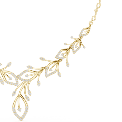 Nature-inspired yellow gold leaf necklace with an elegant vine design and sparkling stone accents by Aortas Jewels.