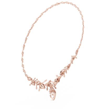 Nature-inspired yellow gold leaf necklace with an elegant vine design and sparkling stone accents by Aortas Jewels.