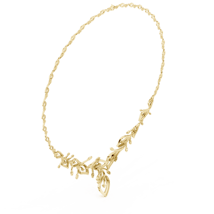 Nature-inspired yellow gold leaf necklace with an elegant vine design and sparkling stone accents by Aortas Jewels.