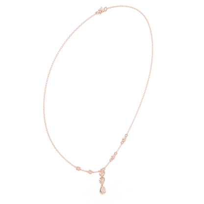 Elegant teardrop diamond pendant necklace with a delicate chain and sparkling accent stones by Aortas Jewels.