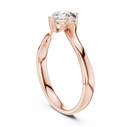 Twisted solitaire diamond engagement ring featuring a round-cut center stone in a four-prong setting with a sleek sculpted twisted band by Aortas Jewels.